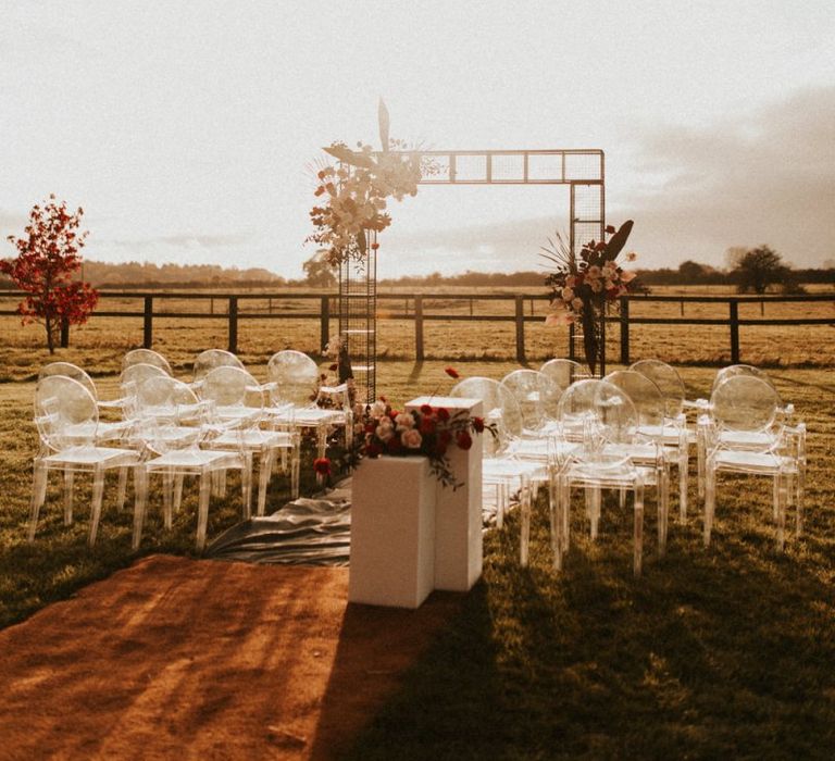 Outdoor wedding ceremony at Godwick Great Barn during golden hour