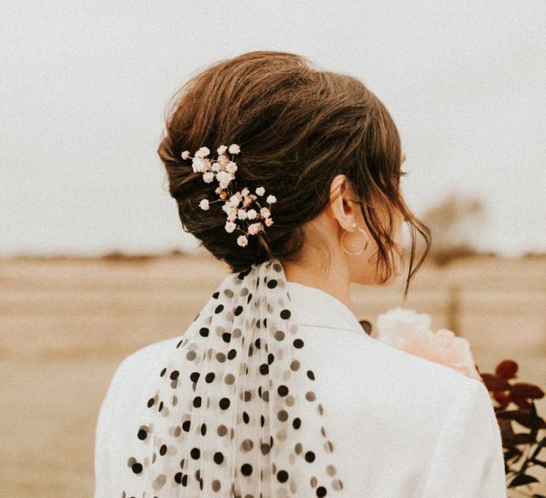 Bride with French roll with black polka dot veil and gypsophila