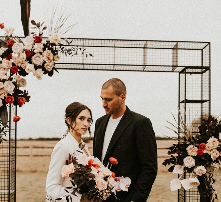 Stylish bride and groom at Godwick Great Barn outdoor ceremony