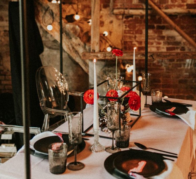 Intimate wedding table with ghost chairs, retro stationery and hanging installation