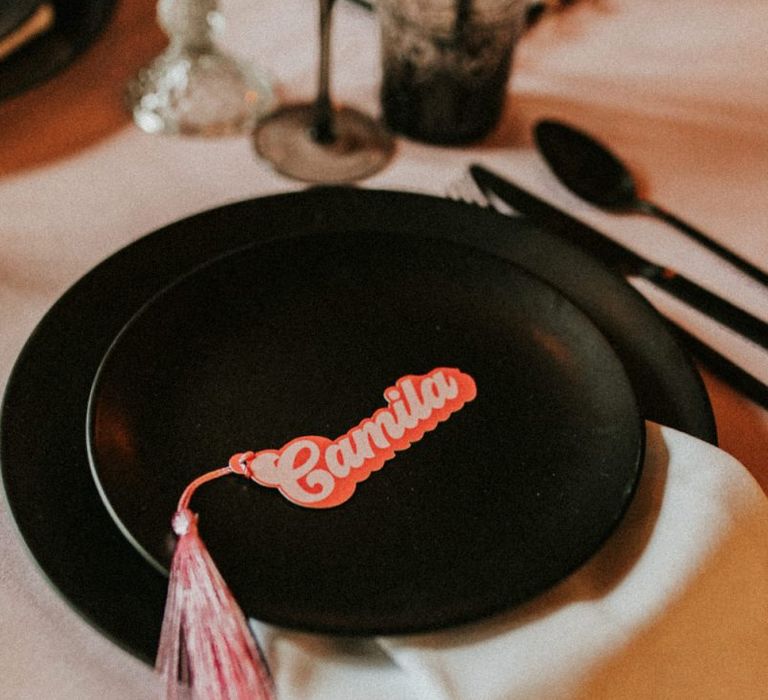 Black tableware and retro name place card with tassel