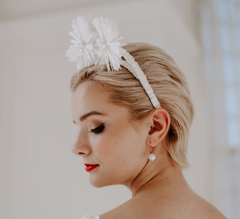 modern wedding ideas with bride with short hair showing off drop earrings