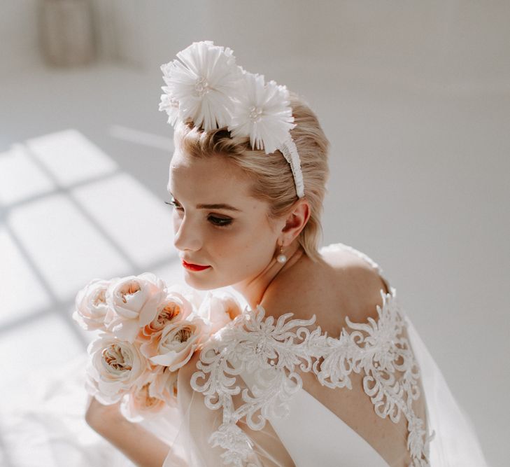 Bride with short hair sitting on the floor with a shadow cast