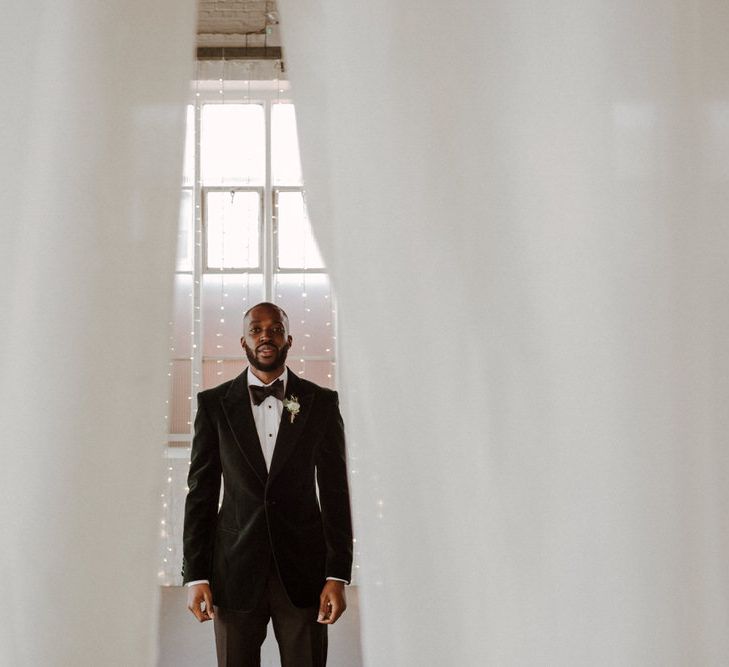 Bride wears dress by Pronovias. Groom wears green velvet blazer from Gieves &amp; Hawkes in this Green And White Luxe, City Wedding. Photography by The Curries.