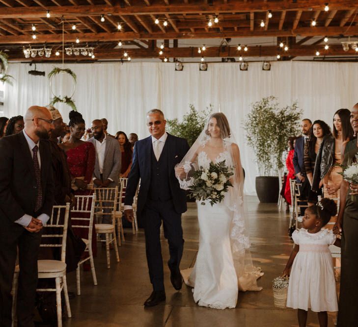 The Ceremony. Bride wears dress by Pronovias. Groom wears green velvet blazer from Gieves &amp; Hawkes in this Green And White Luxe, City Wedding. Photography by The Curries.