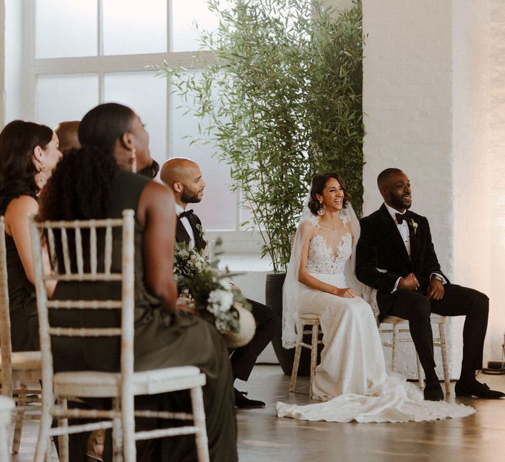 The Ceremony. Bride wears dress by Pronovias. Groom wears green velvet blazer from Gieves &amp; Hawkes in this Green And White Luxe, City Wedding. Photography by The Curries.