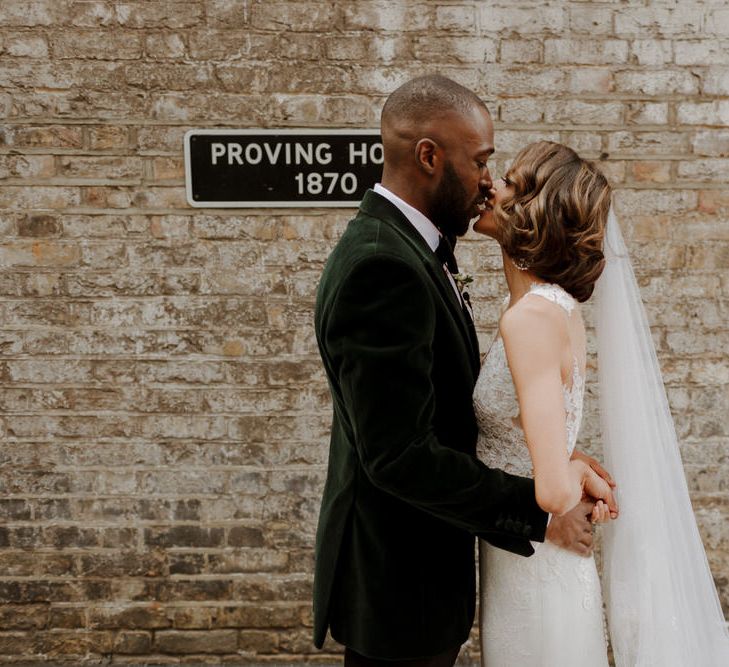 Bride wears dress by Pronovias. Groom wears green velvet blazer from Gieves &amp; Hawkes in this Green And White Luxe, City Wedding. Photography by The Curries.