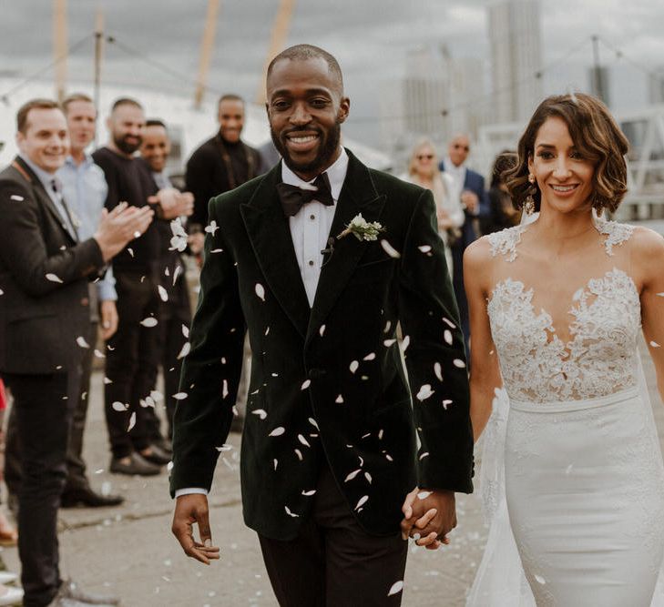 Bride wears dress by Pronovias. Groom wears green velvet blazer from Gieves &amp; Hawkes in this Green And White Luxe, City Wedding. Photography by The Curries.