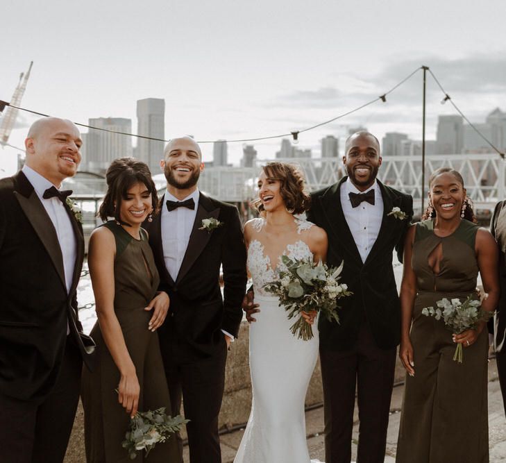 Bridal Party. Bride wears dress by Pronovias. Groom wears green velvet blazer from Gieves &amp; Hawkes in this Green And White Luxe, City Wedding. Photography by The Curries.