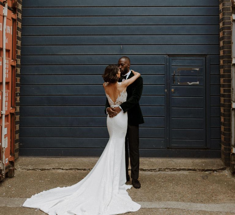 Bride wears dress by Pronovias. Groom wears green velvet blazer from Gieves &amp; Hawkes in this Green And White Luxe, City Wedding. Photography by The Curries.