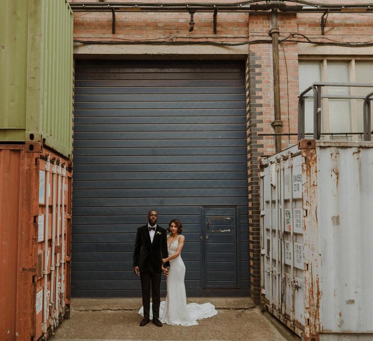 Bride wears dress by Pronovias. Groom wears green velvet blazer from Gieves &amp; Hawkes in this Green And White Luxe, City Wedding. Photography by The Curries.