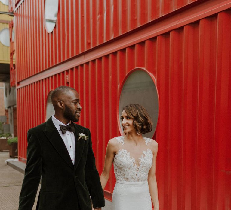 Bride wears dress by Pronovias. Groom wears green velvet blazer from Gieves &amp; Hawkes in this Green And White Luxe, City Wedding. Photography by The Curries.