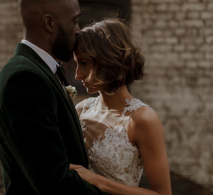 Bride wears dress by Pronovias. Groom wears green velvet blazer from Gieves &amp; Hawkes in this Green And White Luxe, City Wedding. Photography by The Curries.