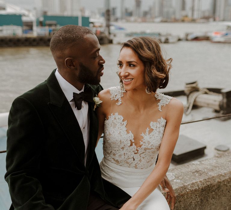 Bride wears dress by Pronovias. Groom wears green velvet blazer from Gieves &amp; Hawkes in this Green And White Luxe, City Wedding. Photography by The Curries.