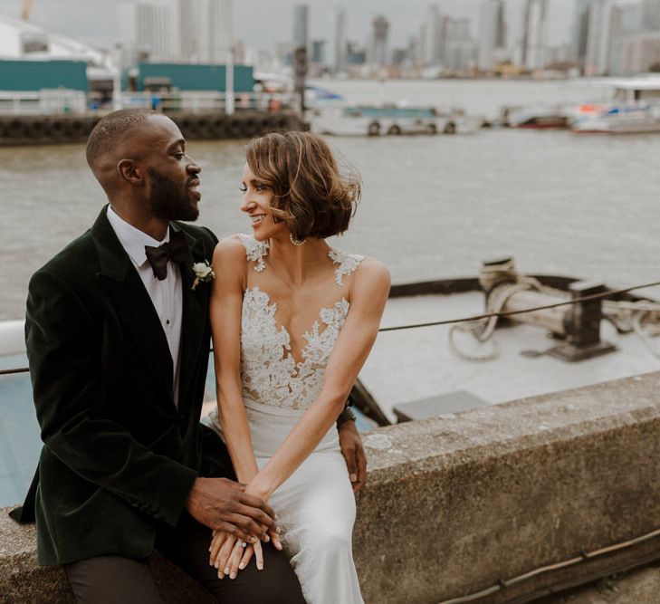 Bride wears dress by Pronovias. Groom wears green velvet blazer from Gieves &amp; Hawkes in this Green And White Luxe, City Wedding. Photography by The Curries.