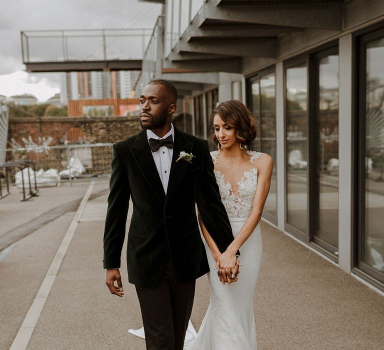 Bride wears dress by Pronovias. Groom wears green velvet blazer from Gieves &amp; Hawkes in this Green And White Luxe, City Wedding. Photography by The Curries.