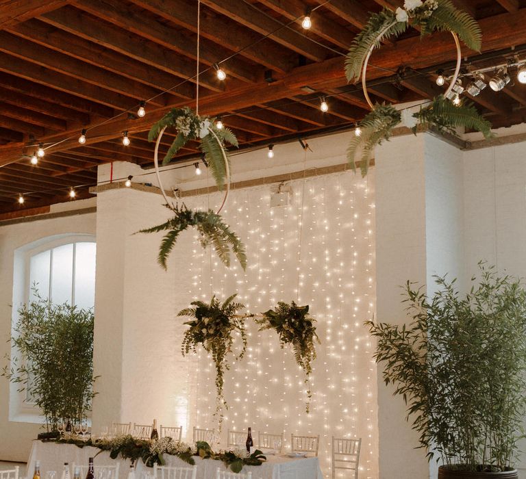 Hoops and Foliage decor for this Green And White Luxe, City Wedding. Photography by The Curries.