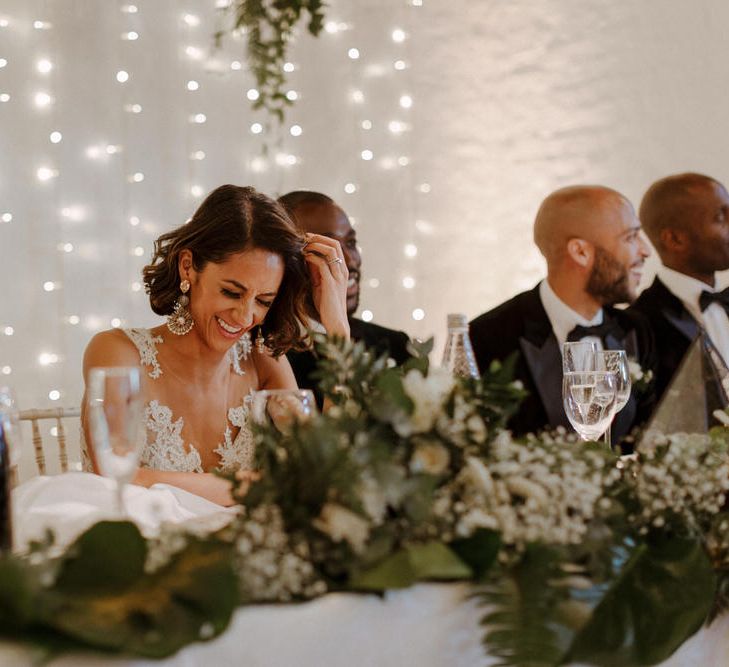 Bride wears dress by Pronovias. Groom wears green velvet blazer from Gieves &amp; Hawkes in this Green And White Luxe, City Wedding. Photography by The Curries.