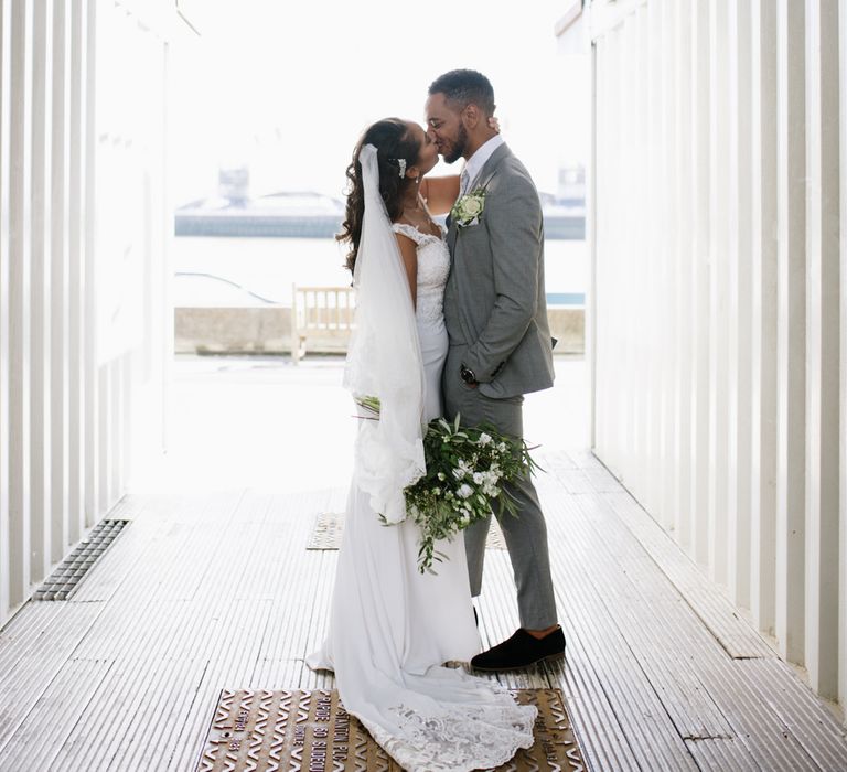 Groom Wears Grey Moss Bros Suit. Modern Warehouse Wedding in London at Trinity Buoy Wharf. Images by Captured by Katrina Photography