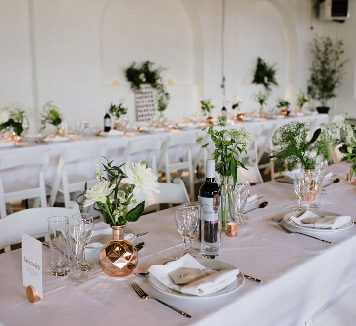 DIY Tile Name Place Settings. Green Foliage with White Roses and Copper Accents. Modern Warehouse Wedding in London at Trinity Buoy Wharf. Images by Captured by Katrina Photography