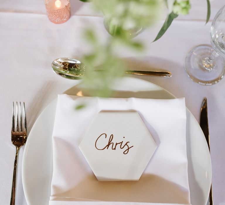 DIY Tile Name Place Settings. Green Foliage with White Roses and Copper Accents. Modern Warehouse Wedding in London at Trinity Buoy Wharf. Images by Captured by Katrina Photography