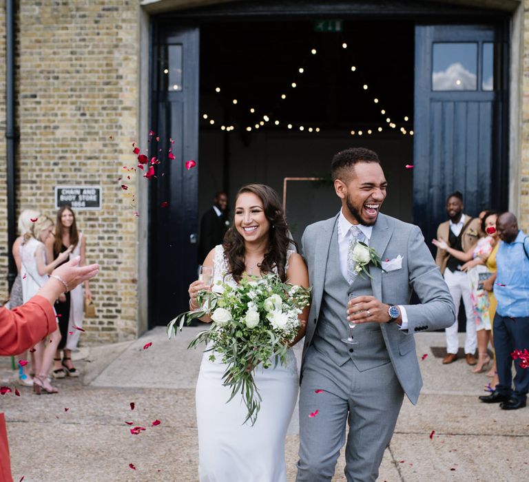 Contrasting Rose Petals for Confetti. Green Foliage and White Roses. Bride Wears Wed2b Dress. Modern Warehouse Wedding in London at Trinity Buoy Wharf. Images by Captured by Katrina Photography