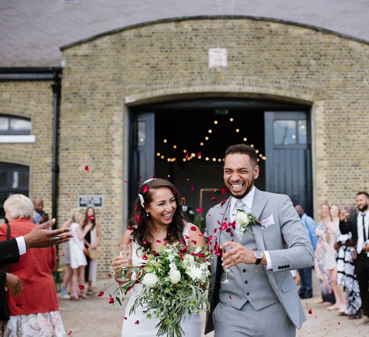 Contrasting Rose Petals for Confetti. Bride Wears Wed2b Dress. Modern Warehouse Wedding in London at Trinity Buoy Wharf. Images by Captured by Katrina Photography