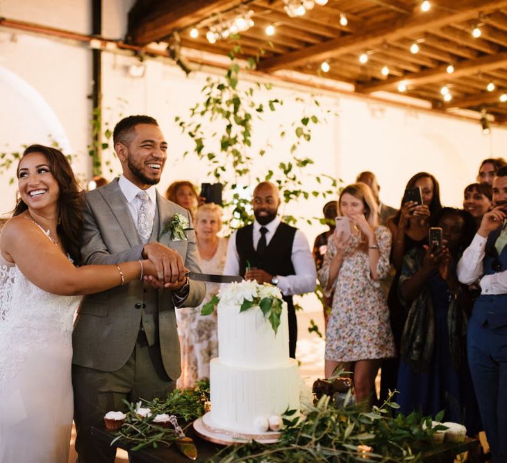 Simple Salted Caramel and White Chocolate Wedding Cake. Green Foliage with White Roses and Copper Accents. Modern Warehouse Wedding in London at Trinity Buoy Wharf. Images by Captured by Katrina Photography