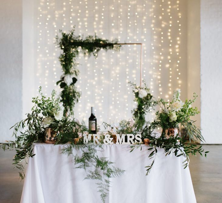 Green Foliage with White Roses and Copper Accents. Modern Warehouse Wedding in London at Trinity Buoy Wharf. Images by Captured by Katrina Photography