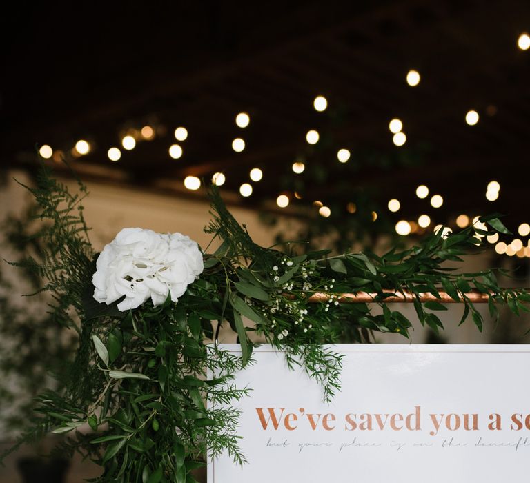 DIY Copper Arbour and Table Plan Stand.  Copper Foiled Table Plan. Green Foliage with White Roses and Copper Accents. Modern Warehouse Wedding in London at Trinity Buoy Wharf. Images by Captured by Katrina Photography