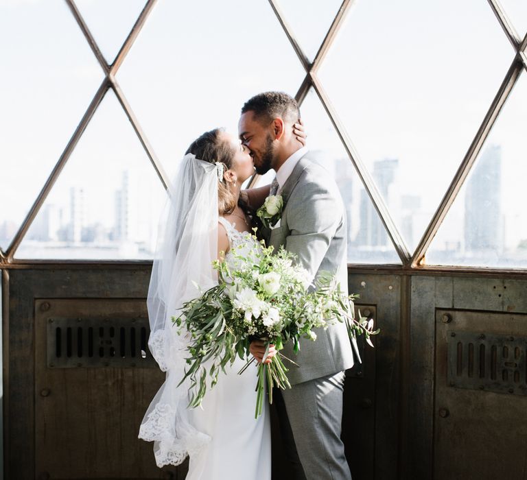 Green Foliage with White Roses and Copper Accents. Modern Warehouse Wedding in London at Trinity Buoy Wharf. Images by Captured by Katrina Photography