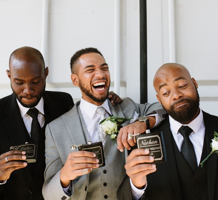 Monochrome Bridal Party Fashion. Groom in Grey Moss Bros. Groomsmen in Their Own Black Suits. Modern Warehouse Wedding in London at Trinity Buoy Wharf. Images by Captured by Katrina Photography