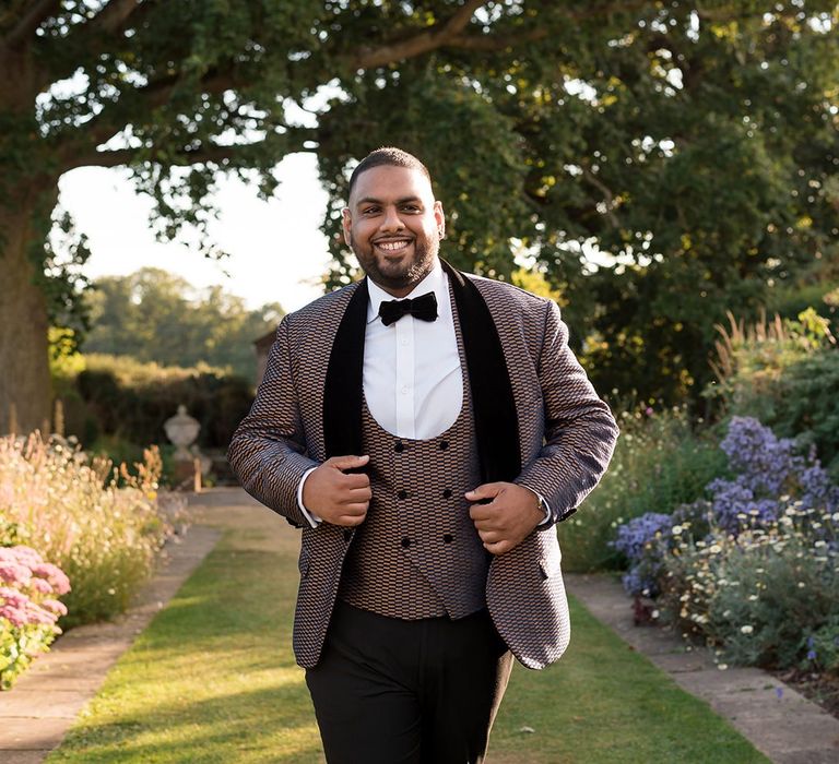 Groom in matching horseshoe waistcoat and dinner jacket and bow tie