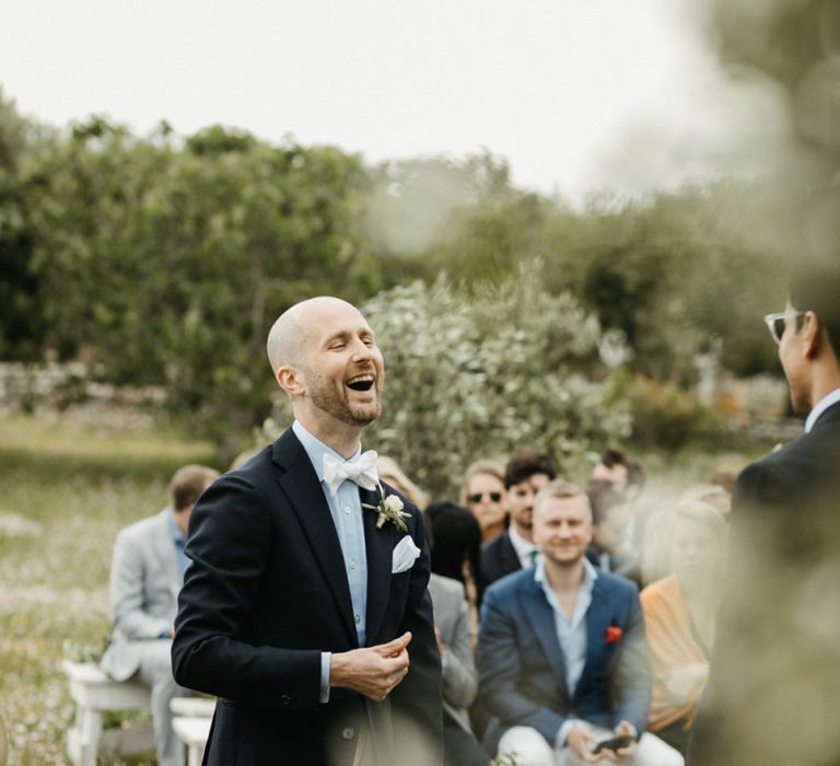 Groom in blue wedding jacket and shirt