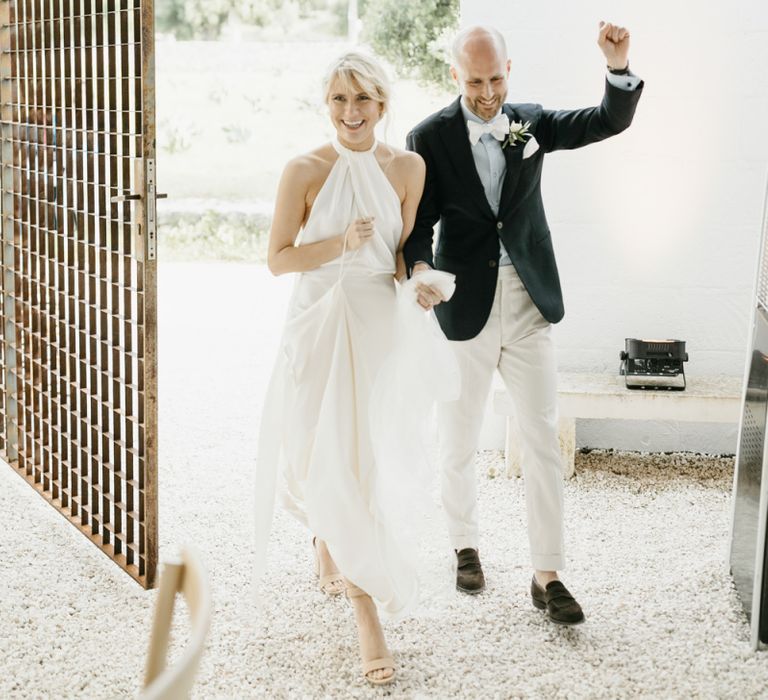 Bride and groom enter wedding breakfast