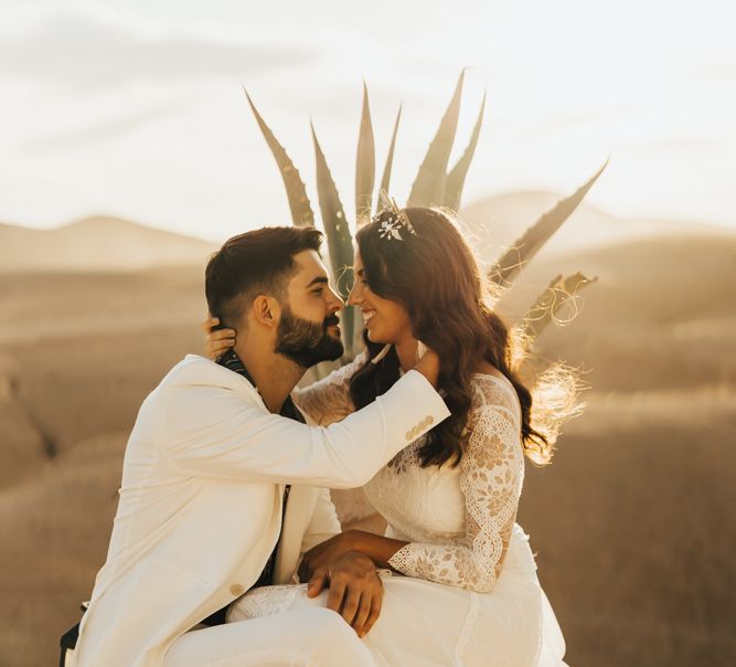 Bride and groom embracing at desert Moroccan wedding