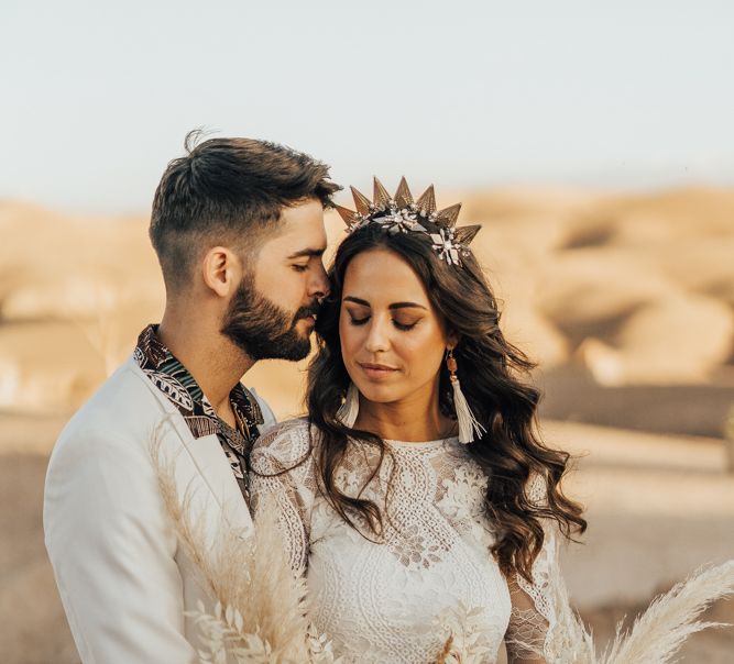 Bohemian bride and groom embracing at desert elopement