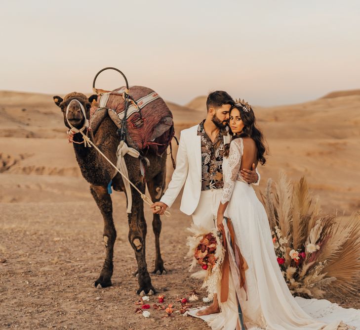 Stylish bride and groom at Morccan wedding with dried flower arrangement  in neutral and rust tones