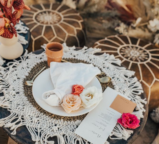 Pace setting with serving platter, macrame table cloth and pouffes