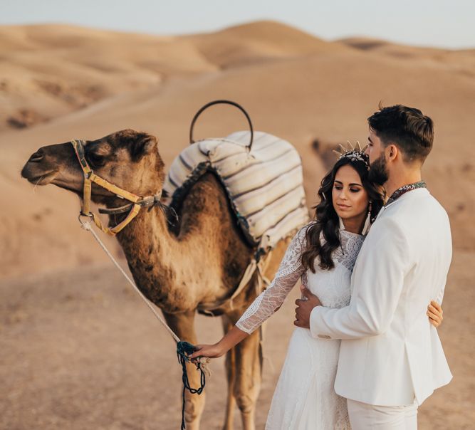 Moroccan wedding with bride and groom holding a camel