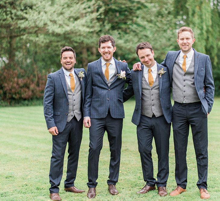 Groom &amp; Groomsmen In Three Piece Suits By Moss Bros. With Coral Ties // Image By Kathryn Hopkins Photography