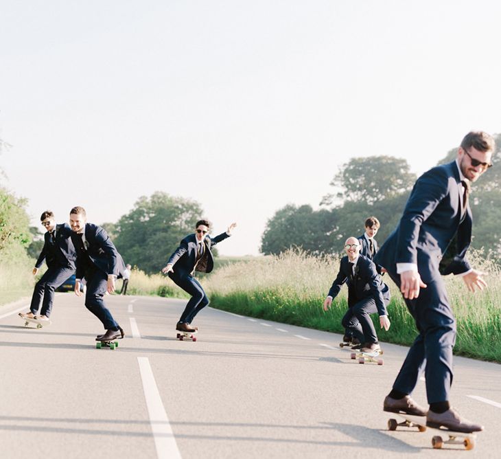 Groom In Navy Suit With Maroon Waistcoat From Moss Bros. // Image By Emma Pilkington