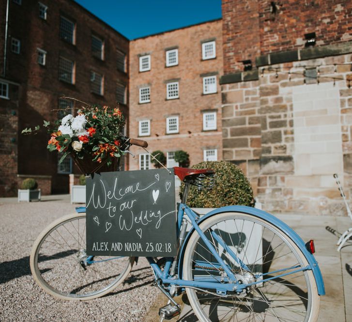 Vintage Bicycle &amp; Chalkboard Welcome Sign Wedding Decor | Copper &amp; Greenery Industrial Winter Wedding at The West Mill Derby, Styled by The Vintage House That Could | Rosie Kelly Photography | Jason Lynch Weddings