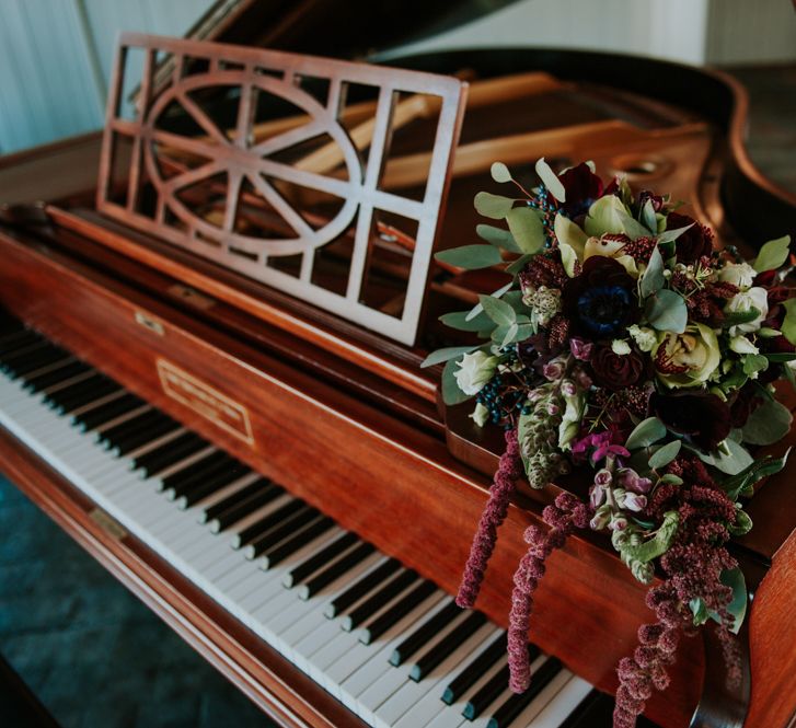 Winter Bouquet on Piano | Copper &amp; Greenery Industrial Winter Wedding at The West Mill Derby, Styled by The Vintage House That Could | Rosie Kelly Photography | Jason Lynch Weddings