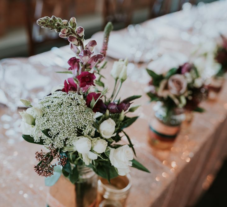 Top Table Wedding Decor Flower Stems in Bottles | Copper &amp; Greenery Industrial Winter Wedding at The West Mill Derby, Styled by The Vintage House That Could | Rosie Kelly Photography | Jason Lynch Weddings