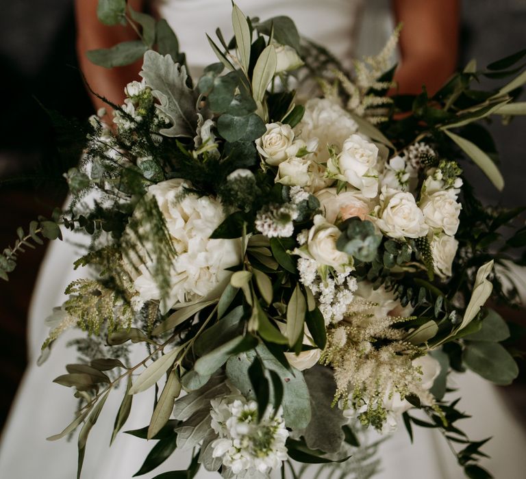 Foliage and flower bouquet for wedding with cupcake wedding cake