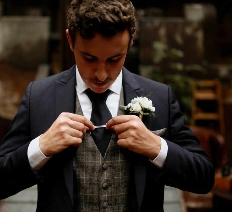 Groom in three piece suit with check waistcoat