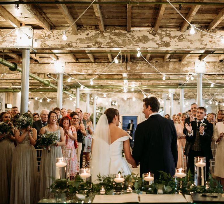 Bride and groom with guests during ceremony