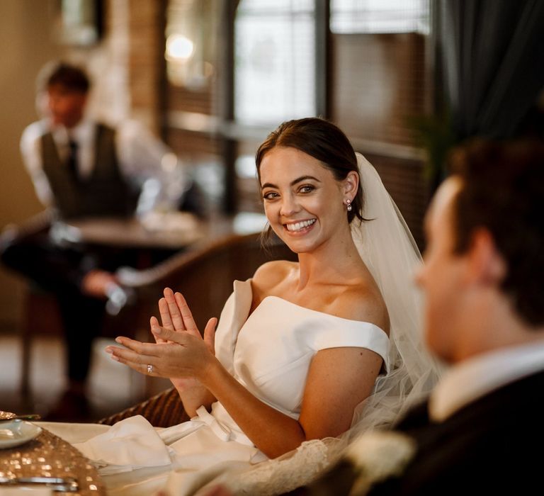 Bride and groom enjoy wedding speeches