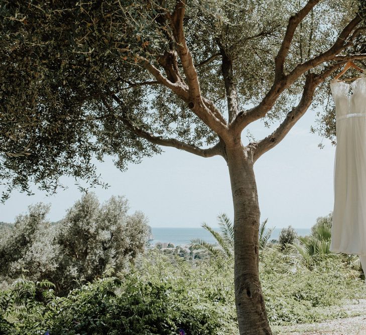 Lace Rembo Styling Wedding Dress Hanging From a Tree